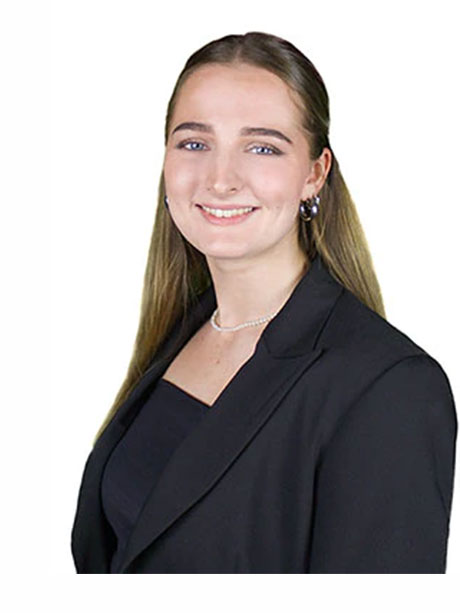 Junge Frau mit langem Haar im schwarzen Blazer, lächelt.
