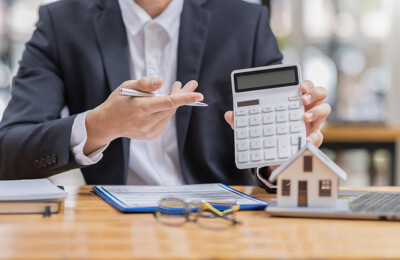 Mann hält einen Taschenrechner