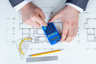 Immobilienmakler mit Unterlagen berechnet die Wohnfläche