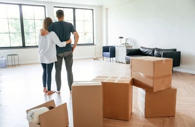 Ein junges Paar freut sich über den Einzug in die neue Wohnung