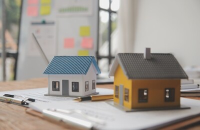 Modellhäuser auf einem Stapel Dokumenten