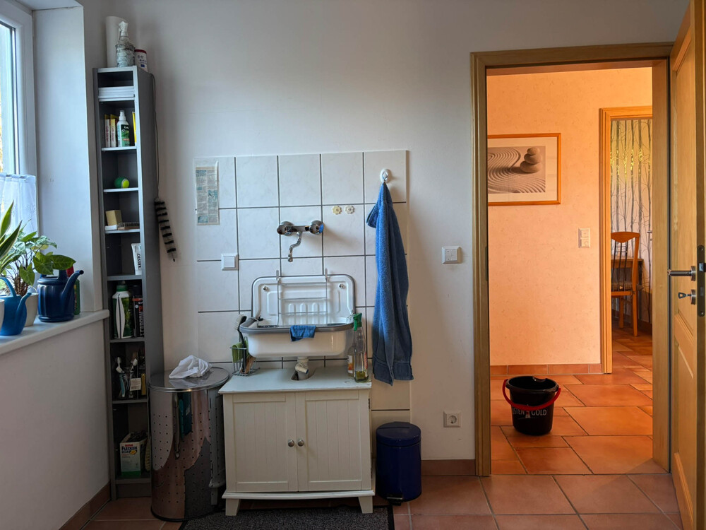 Praktischer Hauswirtschaftsraum mit Durchgang zu Garage und Garten