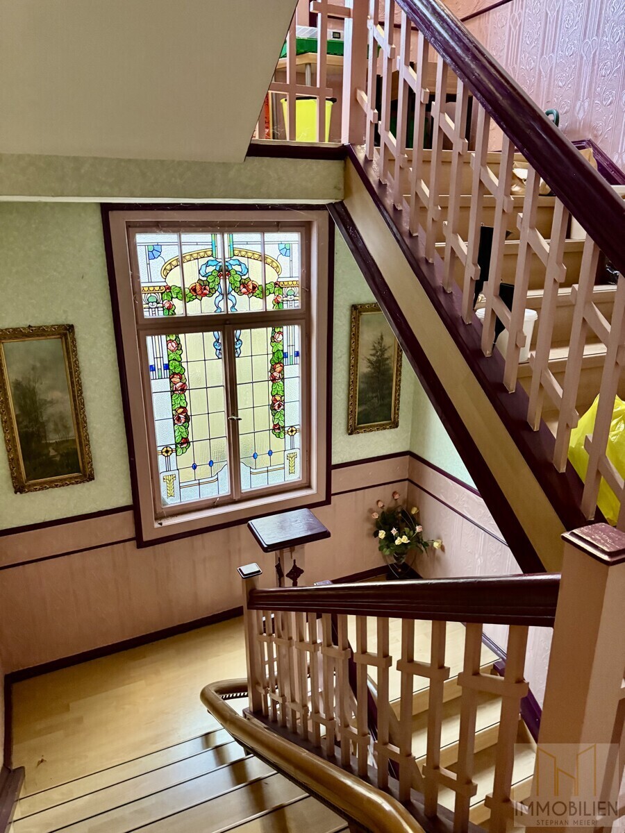 Treppenhaus mit dekorativem Bleiglasfenster