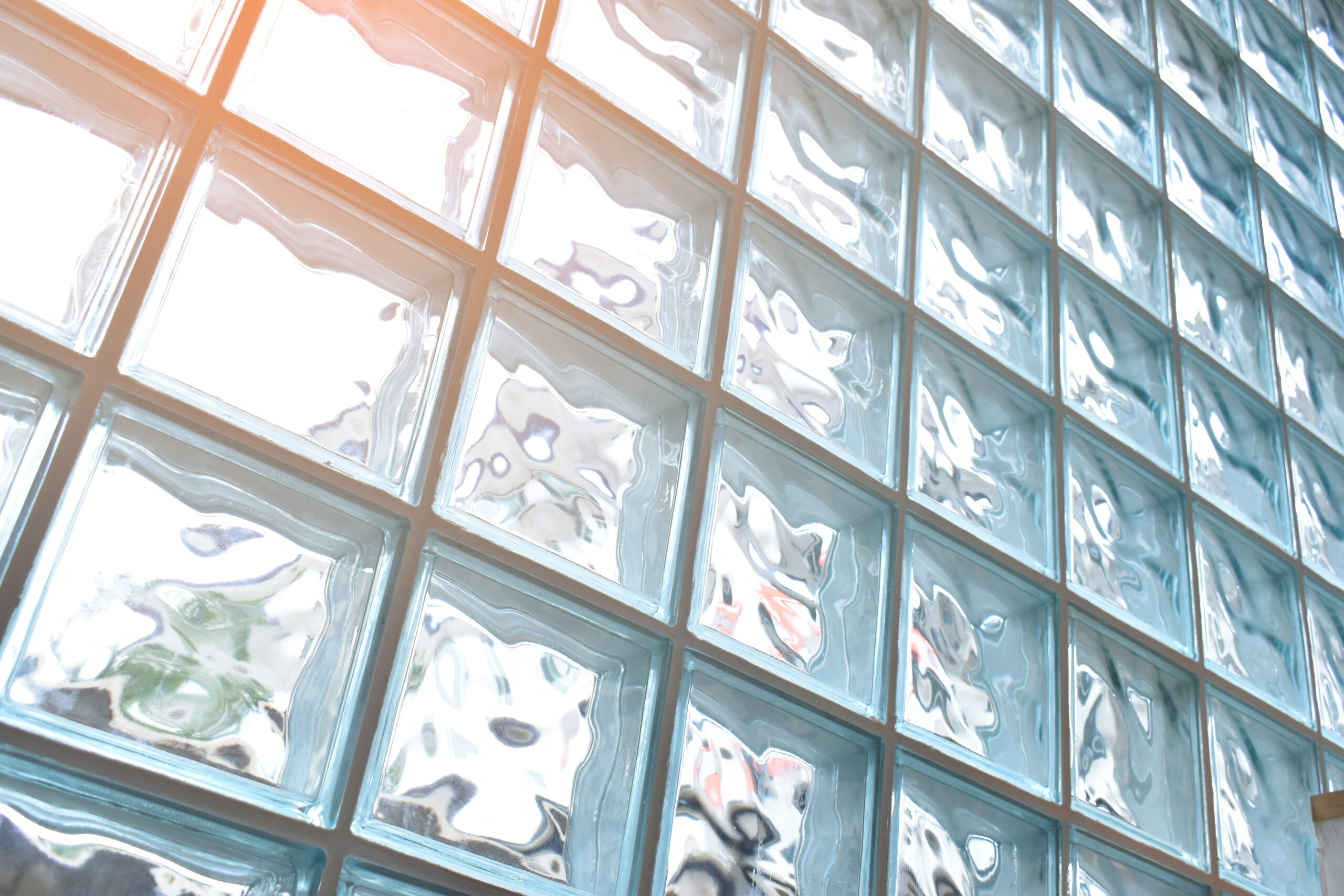 close up glass block wall with golden natural light background, interior design