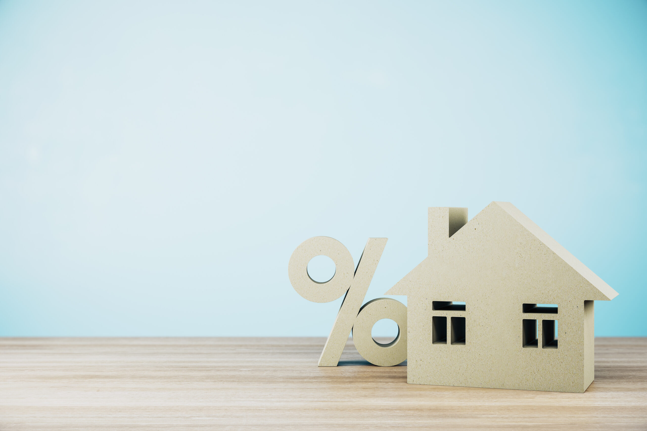 Ein Modellhaus mit einem Prozentzeichen daneben