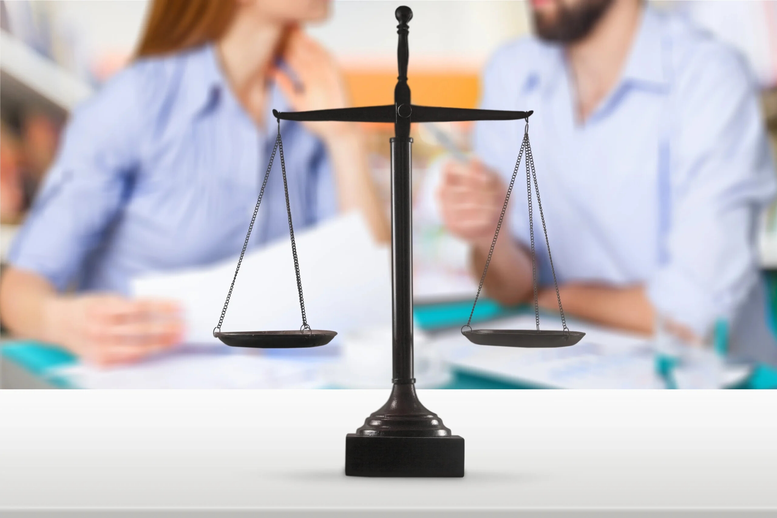 Waage, im Hintergrund zwei Menschen