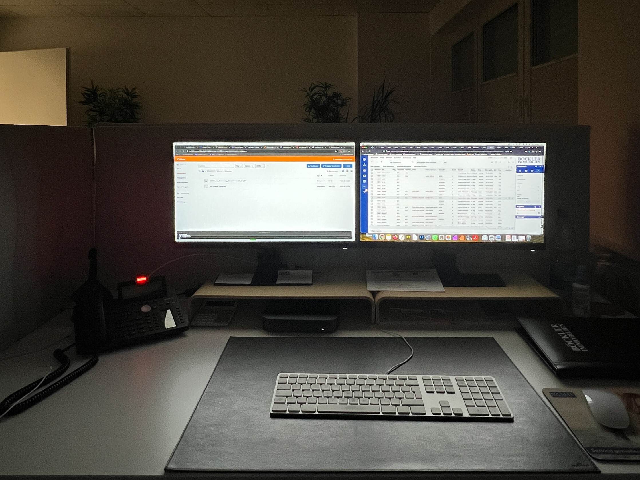 Moderner Arbeitsplatz eines Immobilienmaklers mit zwei Bildschirmen und digitaler Software zur effizienten Verwaltung von Immobilienanfragen und Vermittlungsprozessen