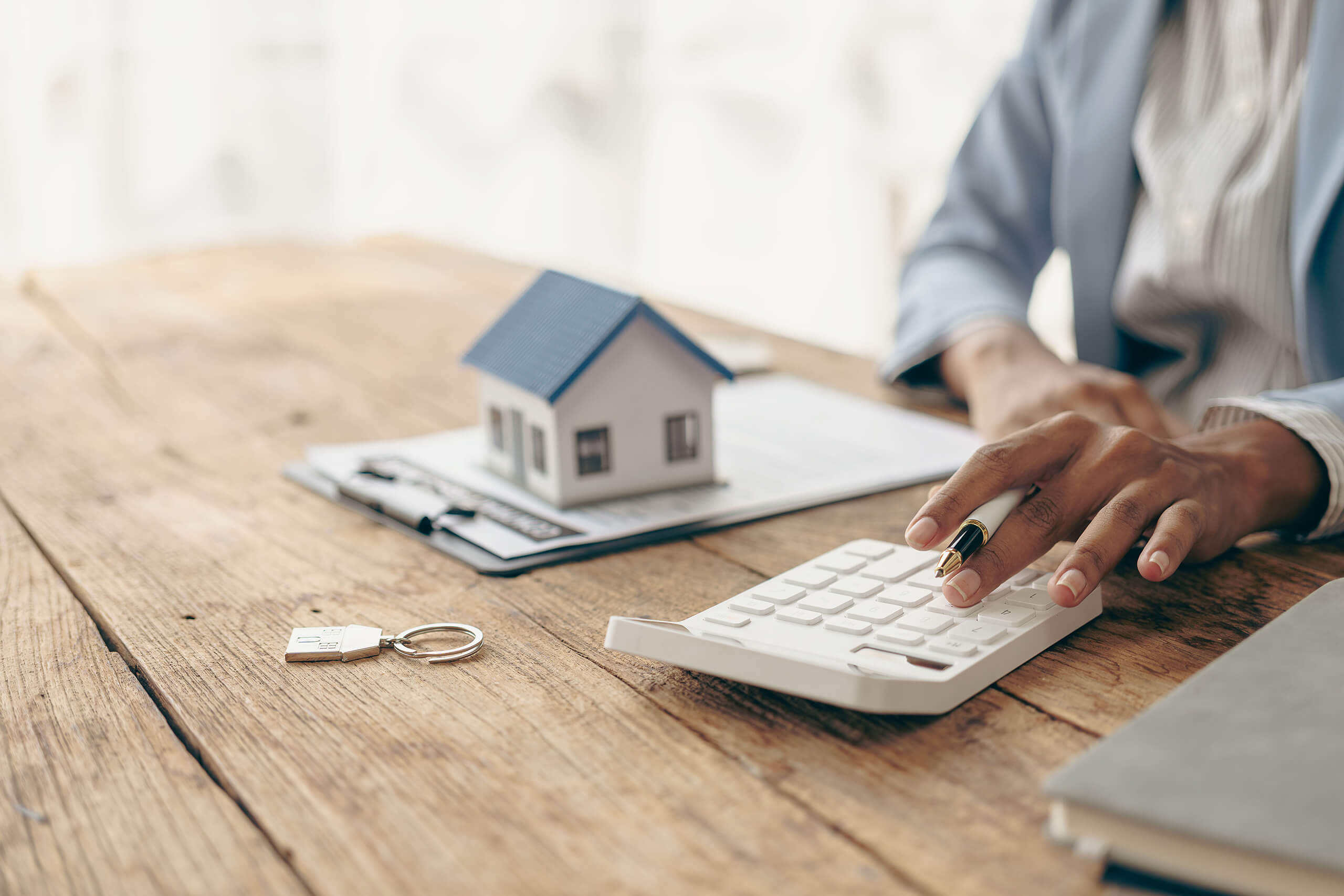 Maklerin errechnet Immobilienwert mit Taschenrechner