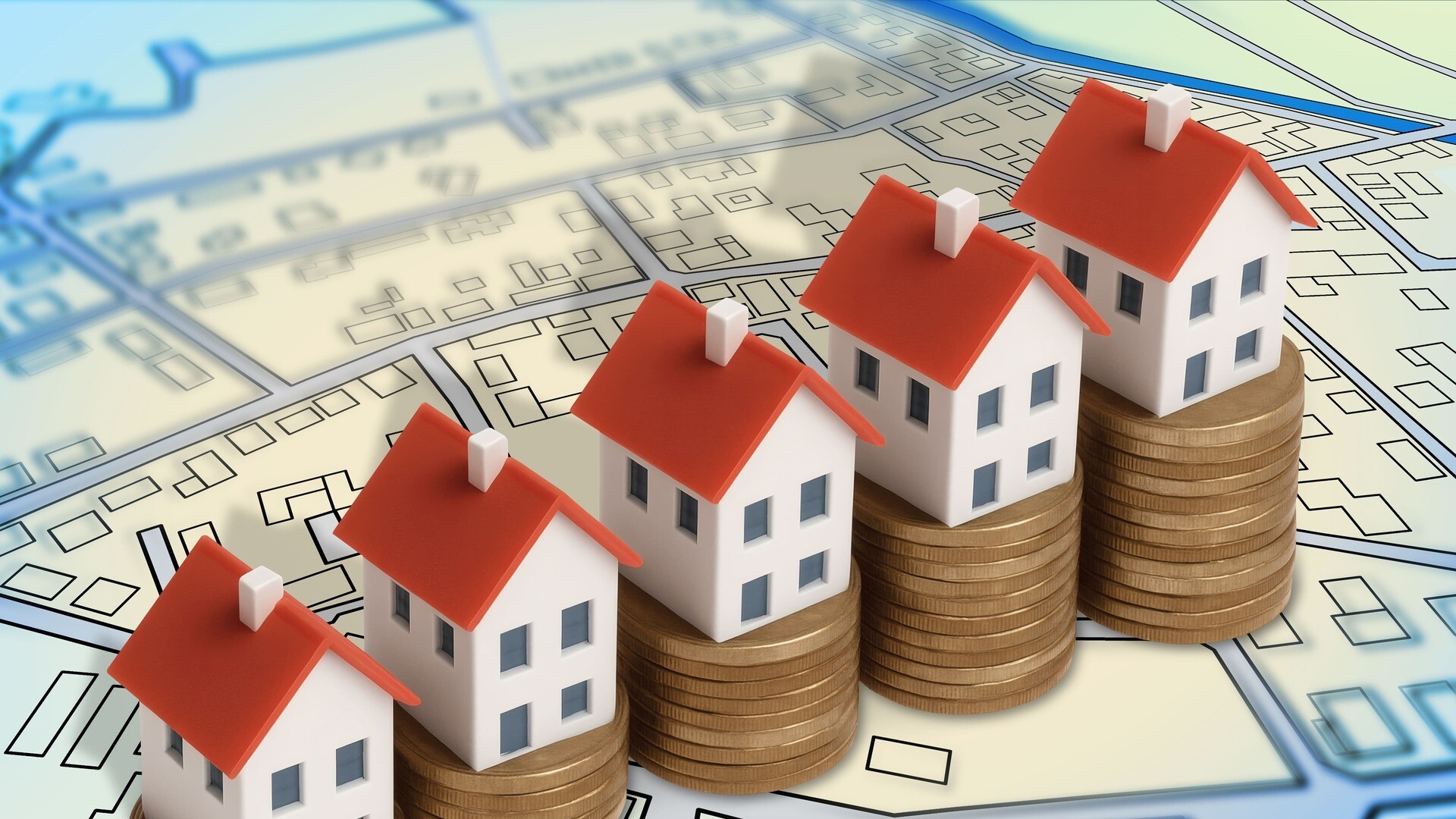 Modellhäuser auf Münzstapeln