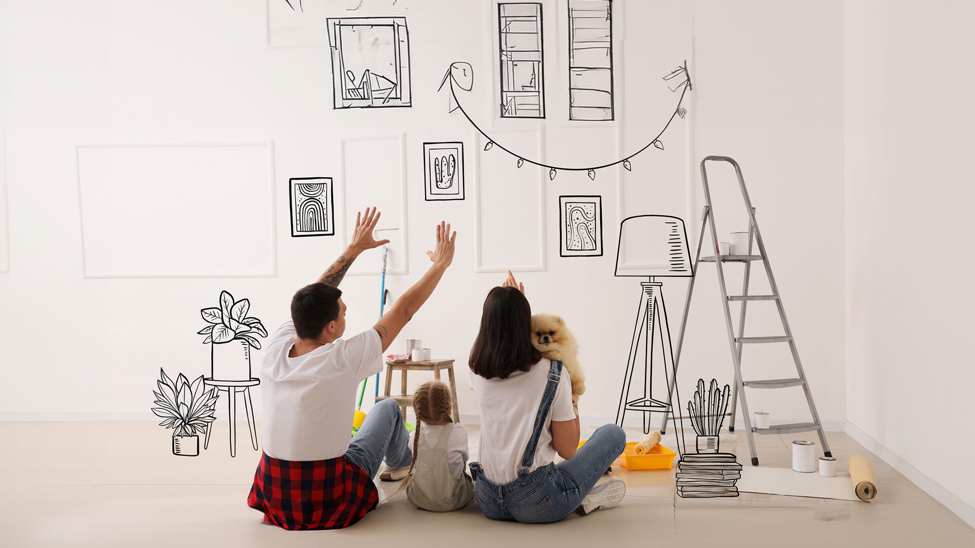 Junge Familie mit einem Hund und einem Kind planen an einer Wand die Gestaltung ihres Zuhauses