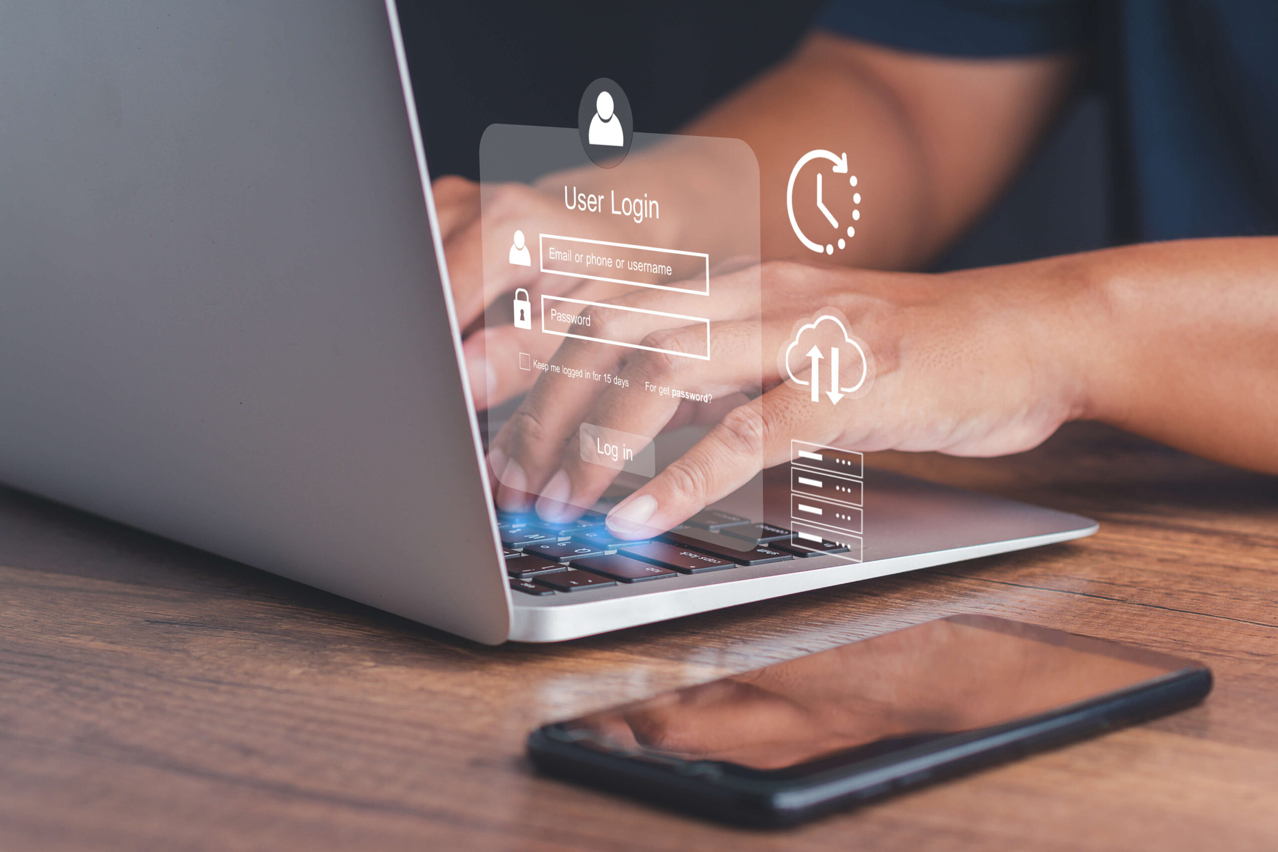 Laptop mit Login-Grafik, Smartphone auf Holztisch in der Nähe