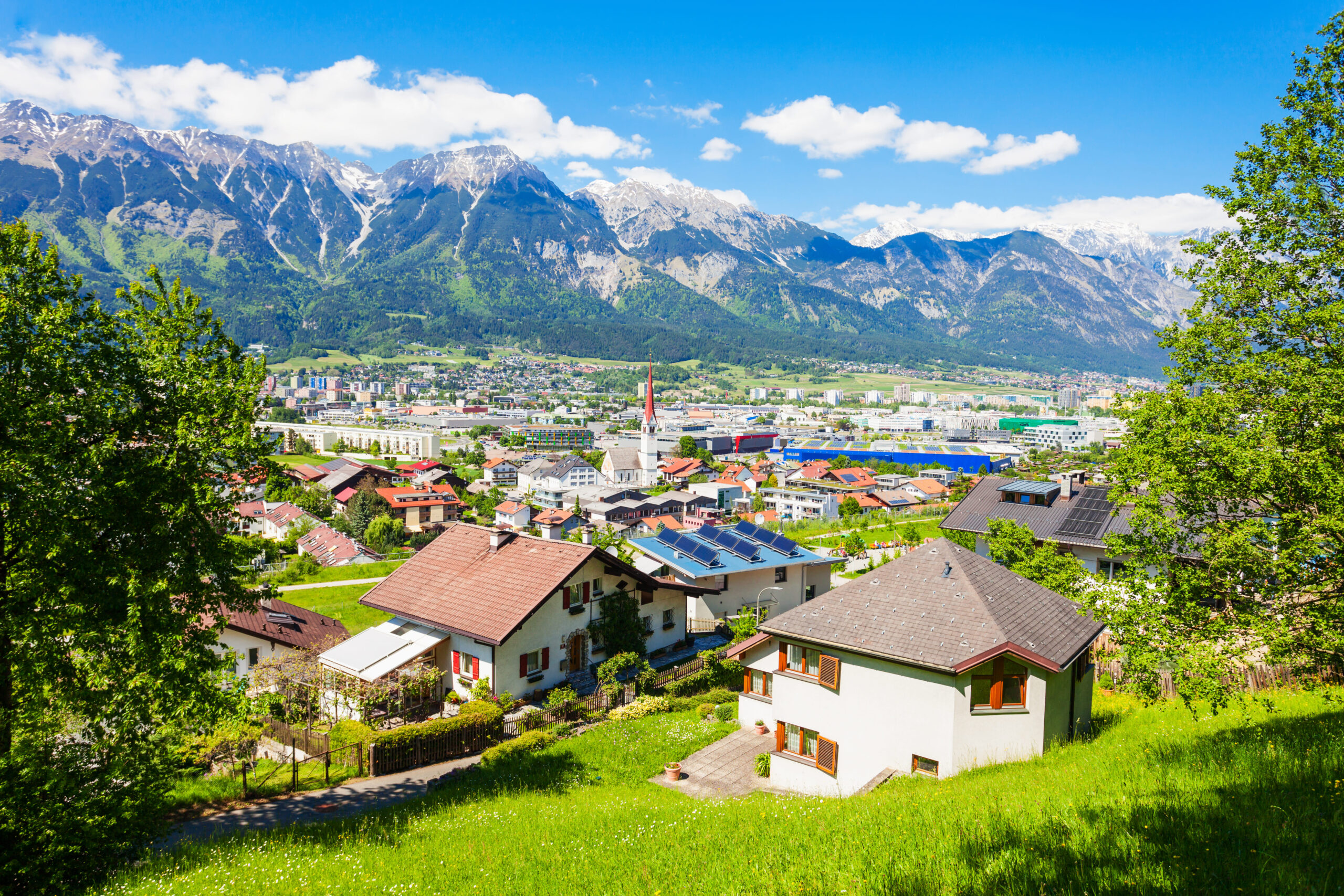 Einfamilienhäuser am Berghang mit Panoramablick über Innsbruck und die Nordkette.