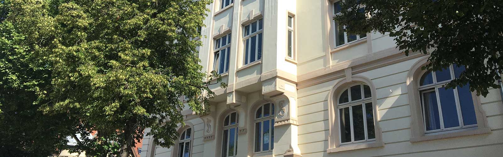 Altbaufassaden mit Bäumen.