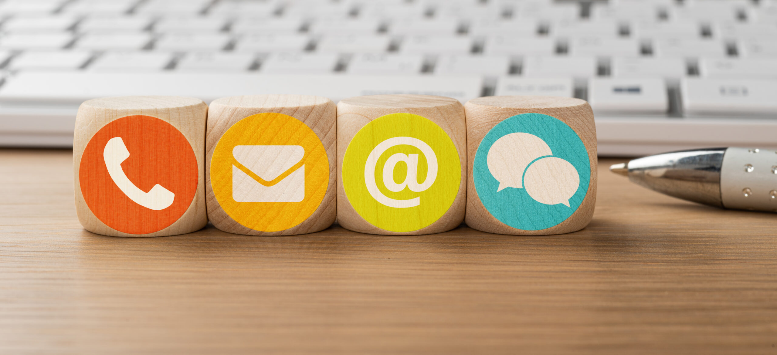 Dice in front of a keyboard - Contact us