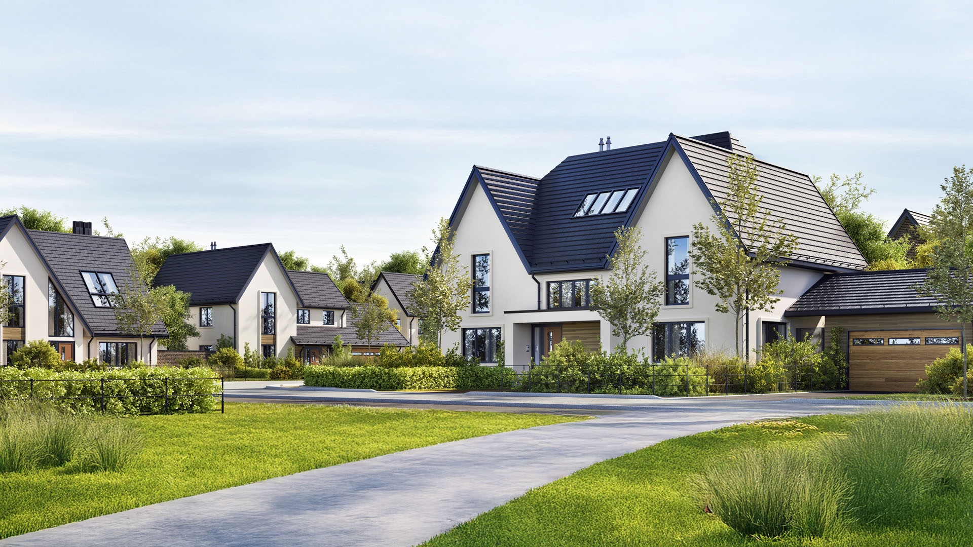 Moderne Vorstadthäuser mit dunklen Dächern und großen Fenstern.