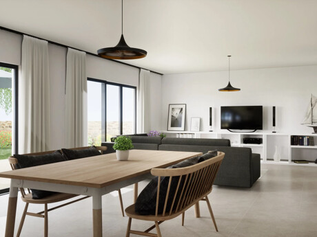 Helles Wohn- und Esszimmer mit Holztisch und grauem Sofa.