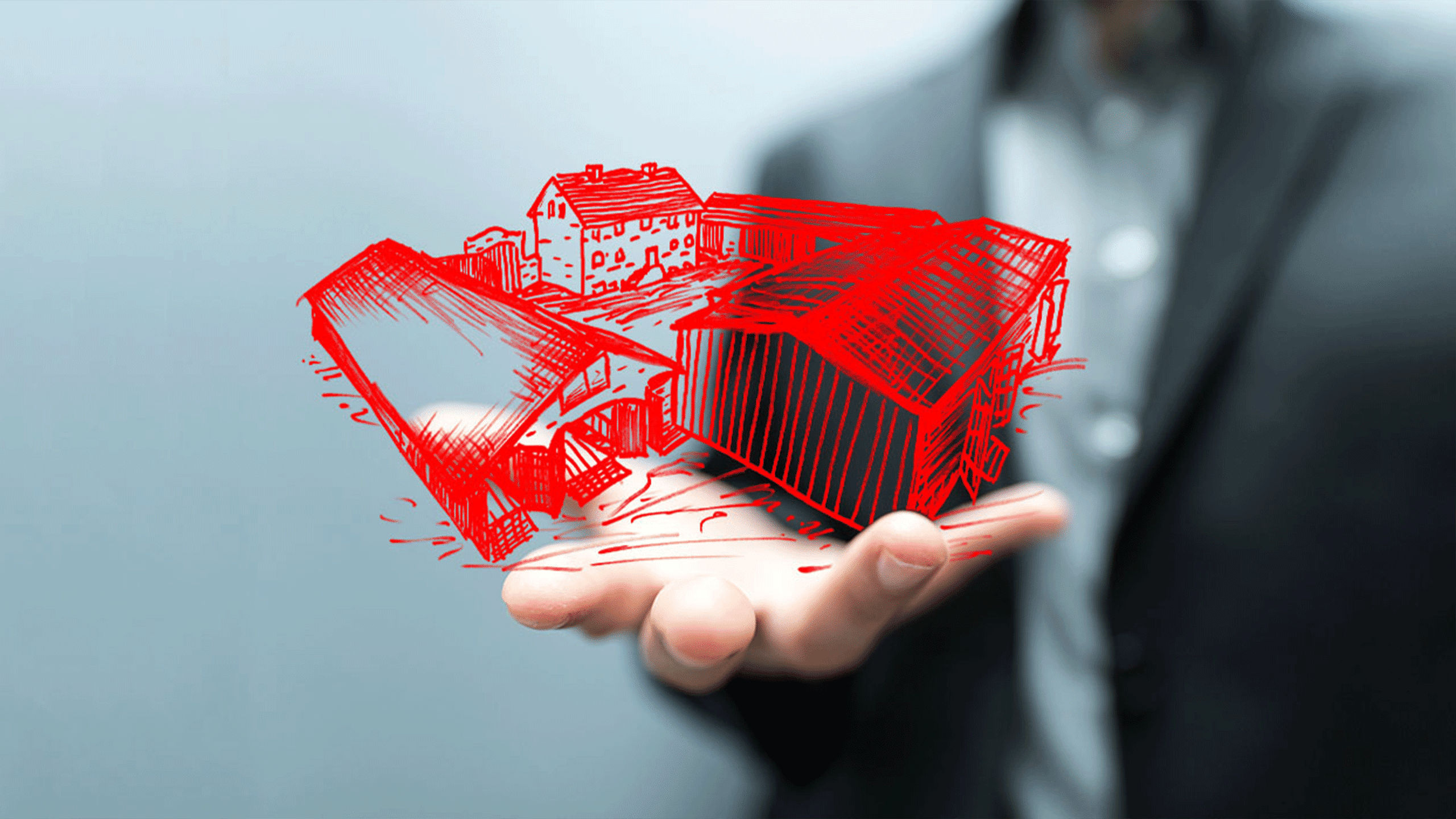 Person hält virtuelle rote Häuser in Hand