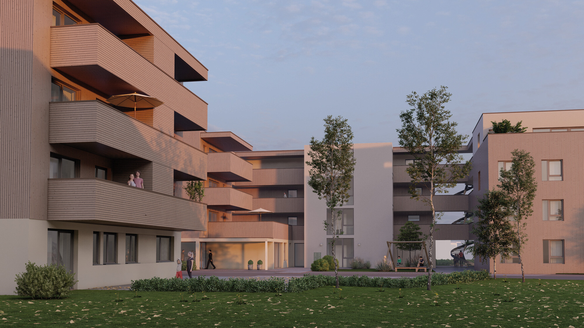 Moderner Wohnkomplex mit Balkonen, Grünfläche und Bäumen bei klarem Himmel