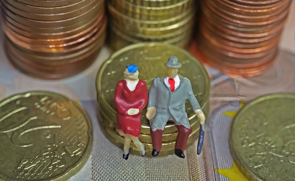 2 kleine Figuren älterer Leute sitzen auf eine paar Euromünzen