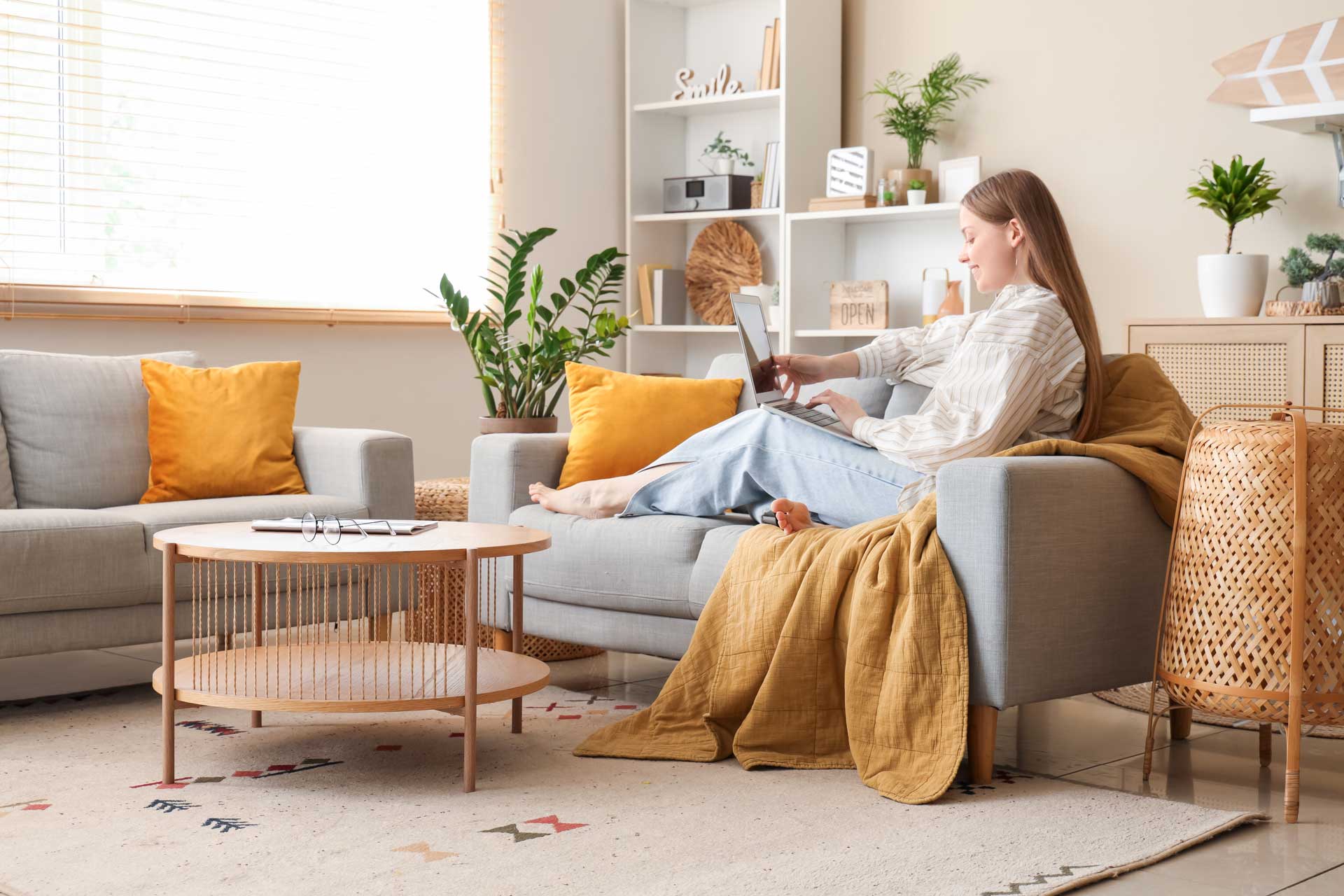 Frau auf grauem Sofa mit Laptop in modernem Wohnzimmer: Wohnung in Nürnberg