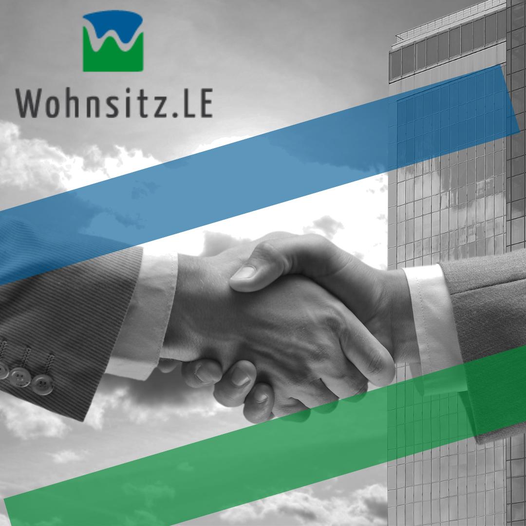 Wohnsitz LE Logo über Handschlag